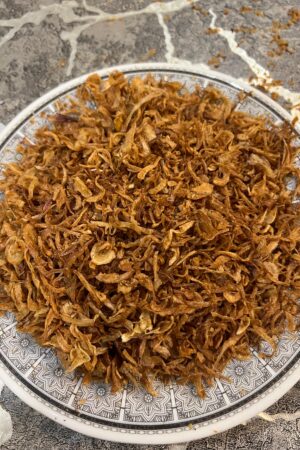 A bowl of crispy fried red onions (laal pyaz) – perfect for biryani and traditional cooking by Pyazon